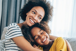 A mother hugs her daughter