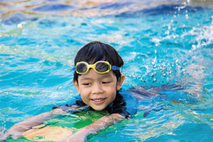 A boy swims in a pool