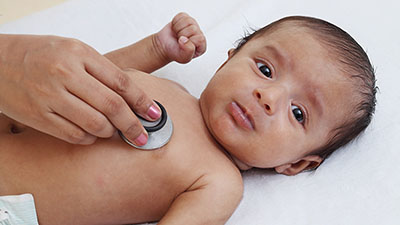 A baby is examined by a doctor